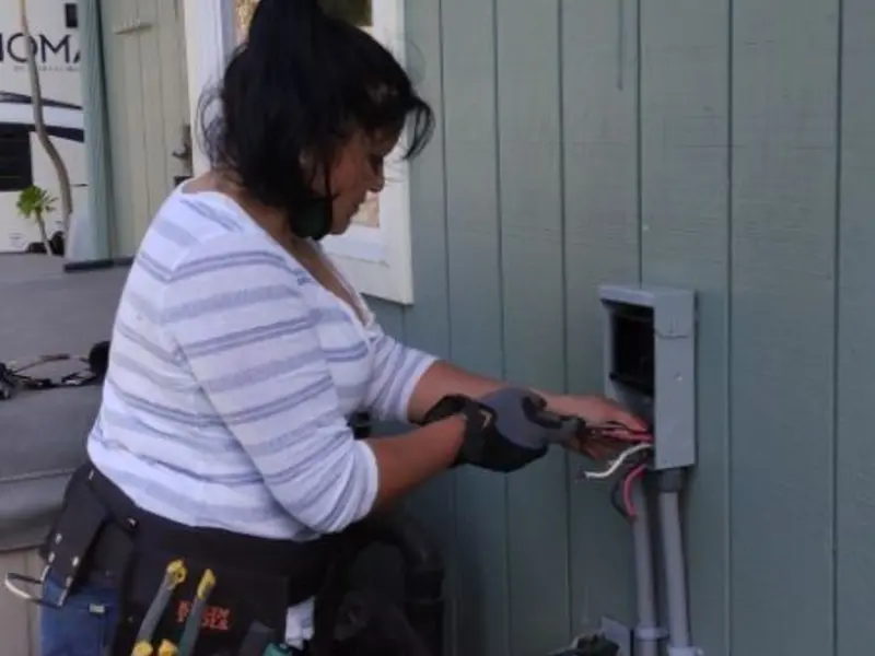 Licensed electrician wiring an exterior subpanel in Byron